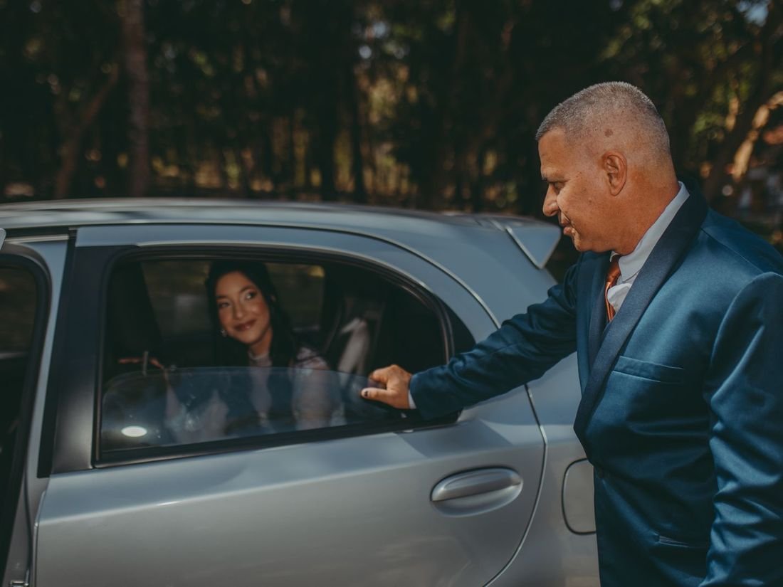 Mangalore Travel Service driver welcoming a passenger into a cab